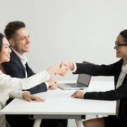 smiling-diverse-businesswomen-shake-hands-group-meeting-deal-concept_1163-4686